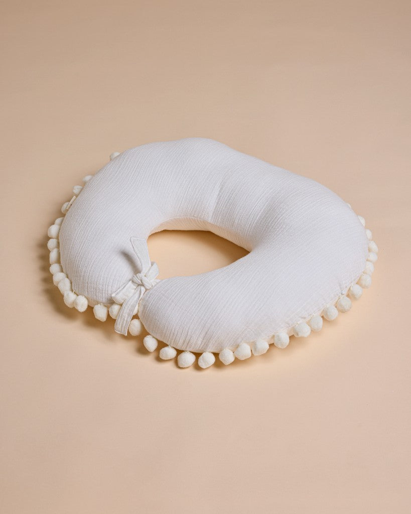 White feeding pillow with pom-pom trim and bow detail – Dreamy by Lil Mulberry